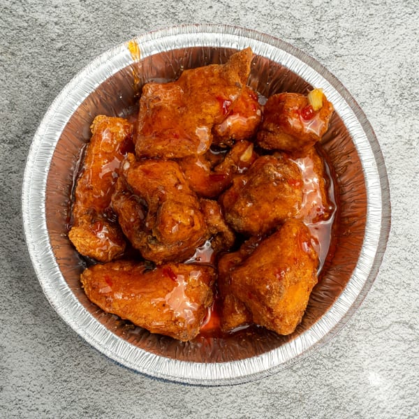 Angie's Soul House's sweet and spicy chicken wings in a foil container.