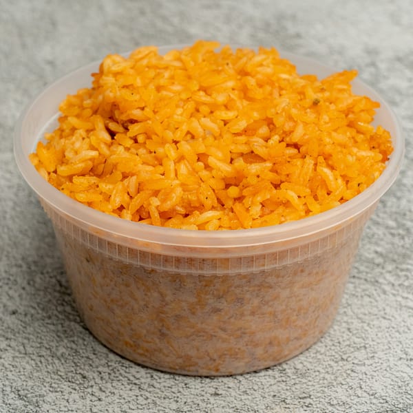 Angie's Soul House's vibrant orange soul food rice in a clear plastic container.
